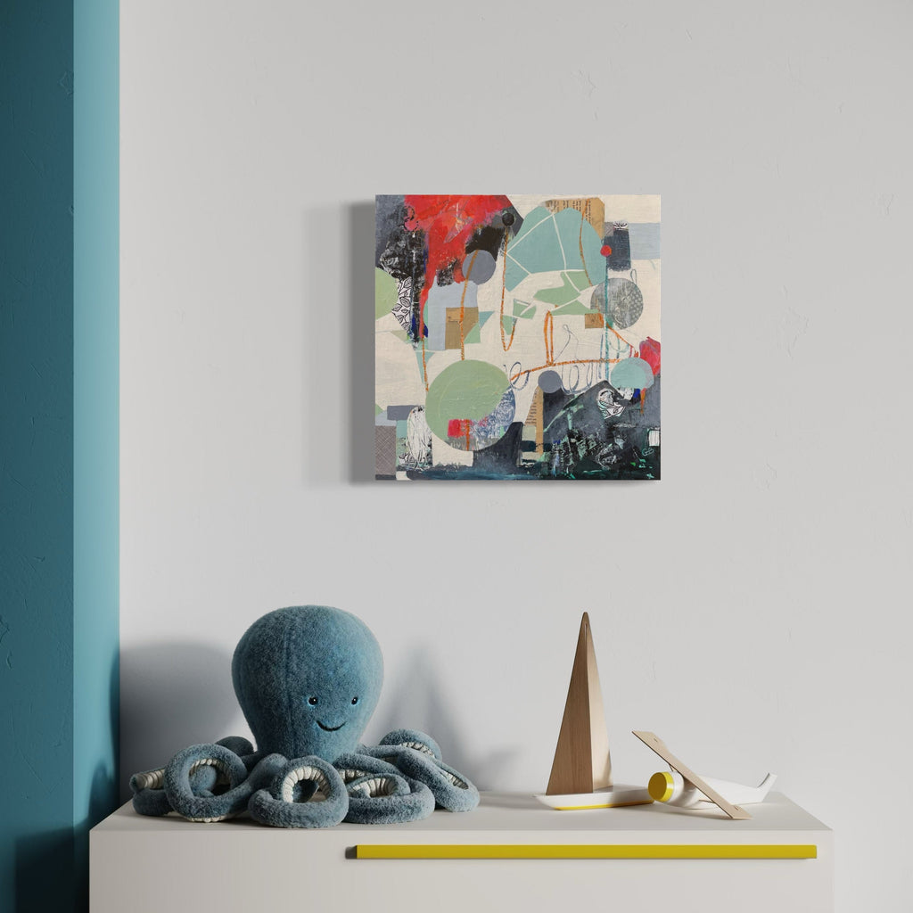 The artwork 'Pendulum' by Giliane Bader features an abstract composition with geometric shapes in muted sage green, coral red, and deep navy blue. Mixed media elements create textural depth on birch panel, with distinctive brushstrokes and layered forms. Cold wax finish adds luminosity to this 16x16 inch contemporary piece.