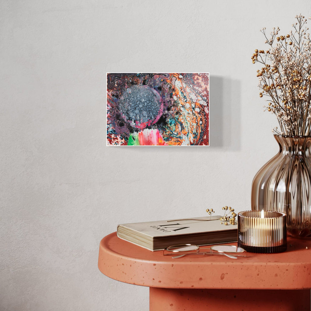 The artwork 'Phantom Planet' by Millie Benson features a celestial-inspired abstract composition with a prominent blue spherical form surrounded by dynamic swirls of coral, purple, and turquoise. Mixed media techniques create textural effects through gouache and spray paint, with explosive color patterns resembling cosmic nebulae on wooden surface by Millie Benson.