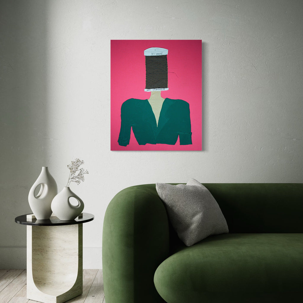 The artwork 'Picking Up The Threads Of Time' by Ali Ha features a surreal collage composition with a large black thread spool replacing a figure's head atop an emerald green blazer, set against a vibrant pink background. The mixed-media piece combines fabric applique with acrylic paint details, creating a striking contemporary statement piece.