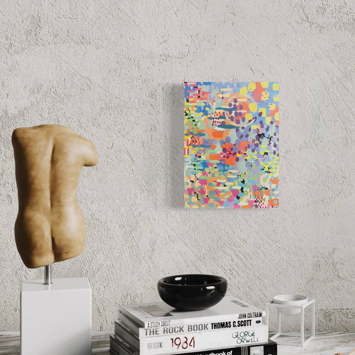 The artwork 'Pixel Rainbow 2' by Alexandra Jamieson features vibrant pixelated patterns with splashes of yellow, pink, blue, and orange creating an abstract digital-inspired composition. Gold foil accents shimmer among acrylic paint strokes, while gestural ink marks add dynamic movement across the 12x9 inch canvas, combining modern pixel art with traditional painting techniques.