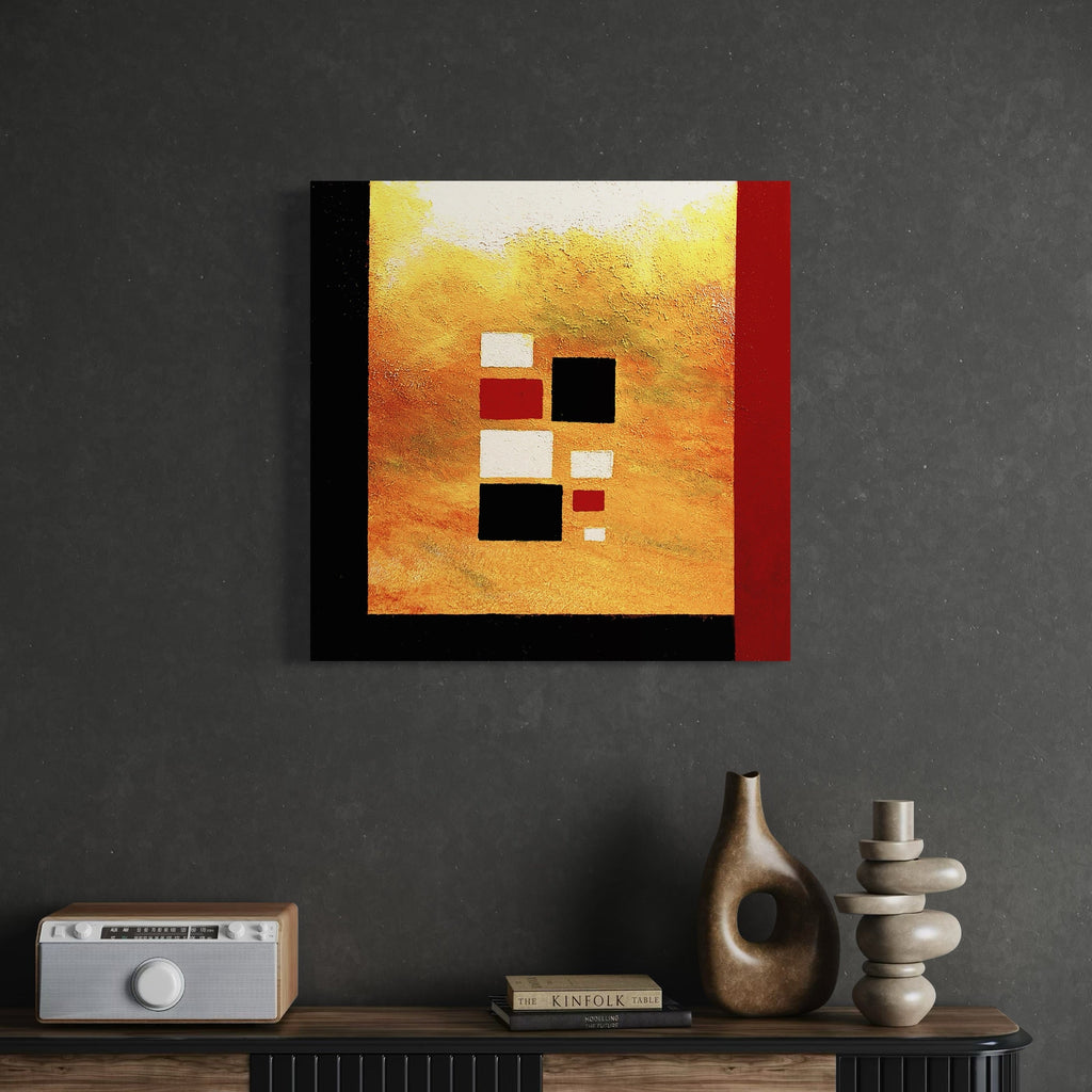 The artwork 'Pueblo #1' by Vanessa Ryan features a striking geometric abstract composition with floating squares in black, white, and deep red against a textured golden-orange background. The canvas incorporates sand mixed with acrylic paint, creating a rich, desert-inspired surface texture reminiscent of Southwestern landscapes and architectural forms.