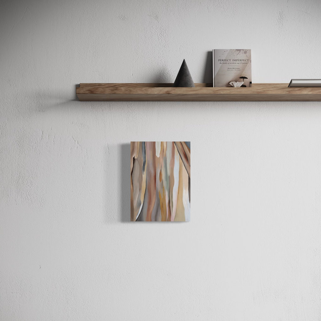 The artwork 'Rainbow Eucalyptus' by Taylor Stoneman features fluid, abstract vertical strokes in muted earth tones of beige, brown, and subtle blue-grey, reminiscent of natural eucalyptus bark patterns. The oil on linen painting, measuring 12x9 inches, displays organic flowing lines creating a harmonious composition against a light background.