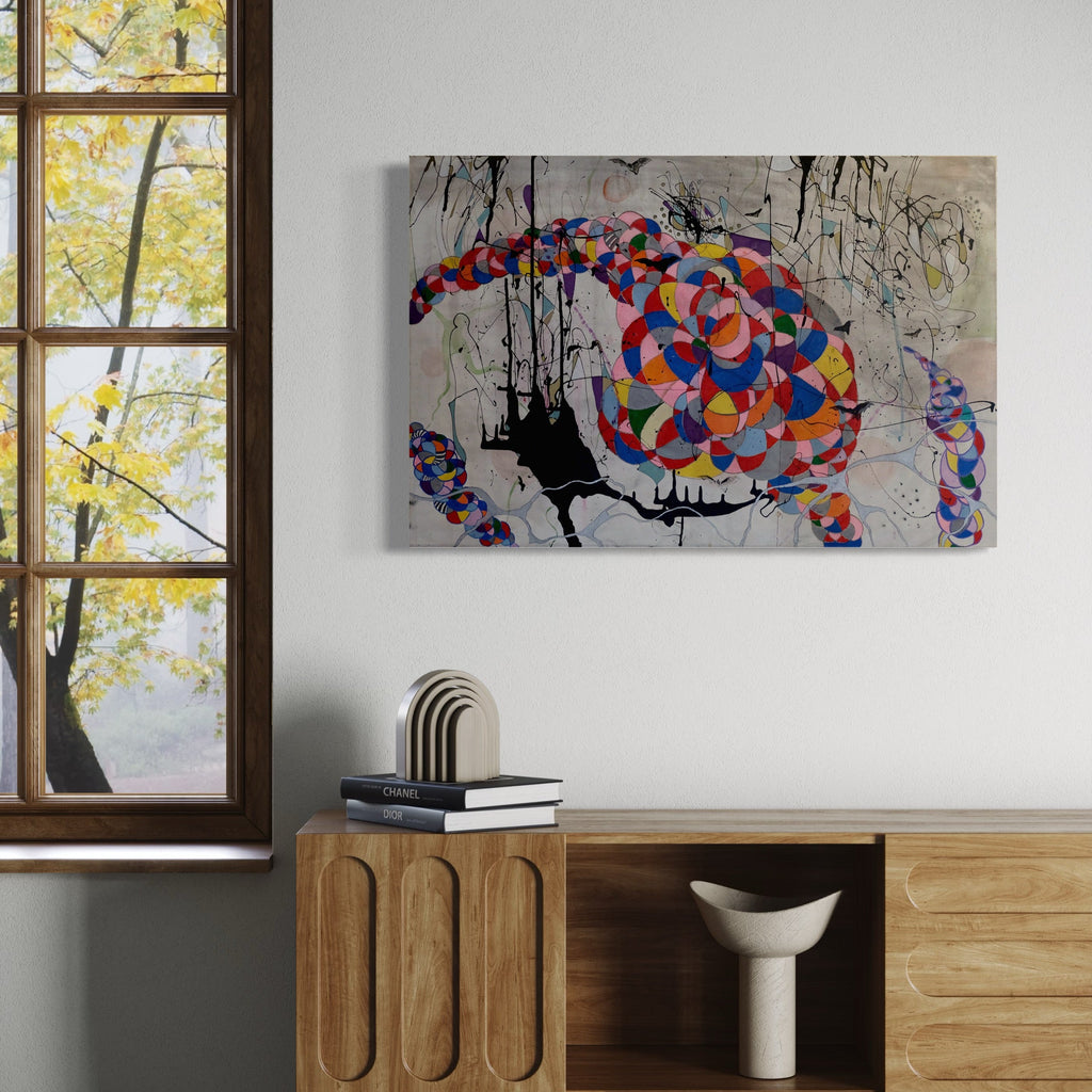 The artwork 'Rainbow vs Tornado' by Devin Ruiz features a dynamic abstract composition with vibrant geometric patterns in red, blue, and orange forming a spiral-like structure against a grayscale background. Black drip elements create a dramatic contrast while geometric circles merge to form a tornado-like shape on mixed media canvas, sized 24x36 inches.