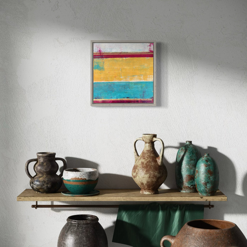 The artwork 'Raw Days' by Karen L. Burns features horizontal color blocks in vibrant red, golden yellow, and turquoise blue, created with acrylic and mixed media. The abstract composition showcases textured brushstrokes and weathered effects, suggesting a raw, natural aesthetic. The 12x12 inch piece evokes a modern coastal or desert landscape with its bold, distressed layering and contemporary color palette.