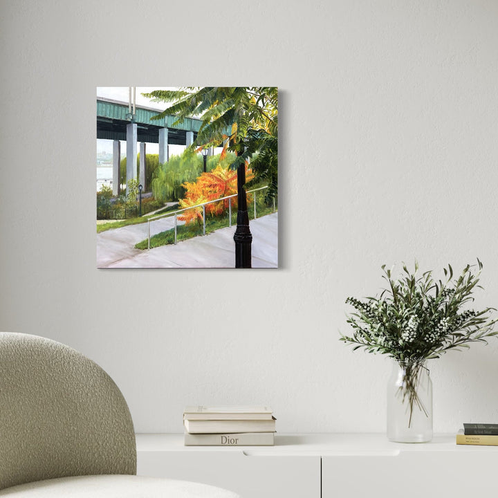 The artwork, River's Edge in Fall, Riverside Park South NYC, by Jessica Ziegler, displayed in a room.
