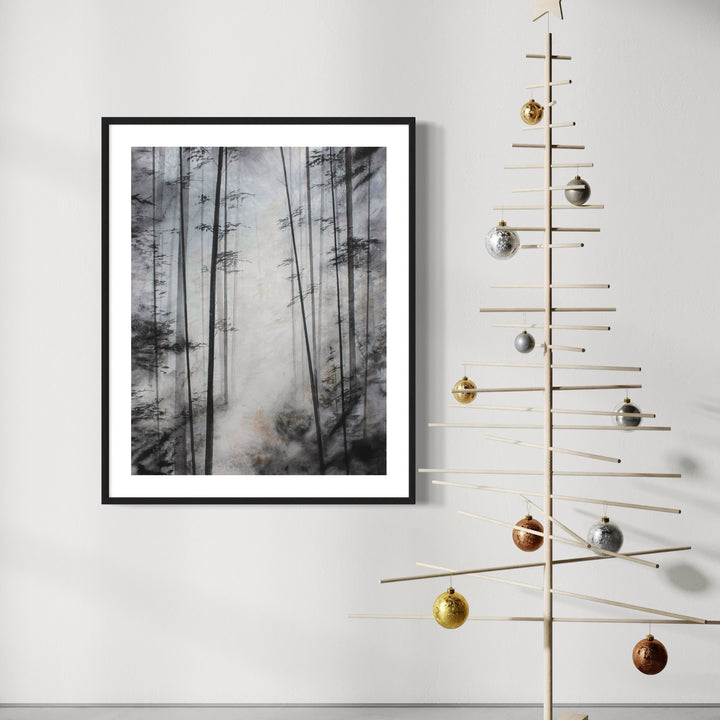 The artwork 'Sacred Path' depicts a mystical forest scene in watercolor, featuring tall, slender tree trunks rising through misty gray atmosphere. The monochromatic composition creates a ethereal depth with darker silhouettes fading into lighter foggy background. Black frame complements the moody, atmospheric nature of the piece. By Cat Lencke.
