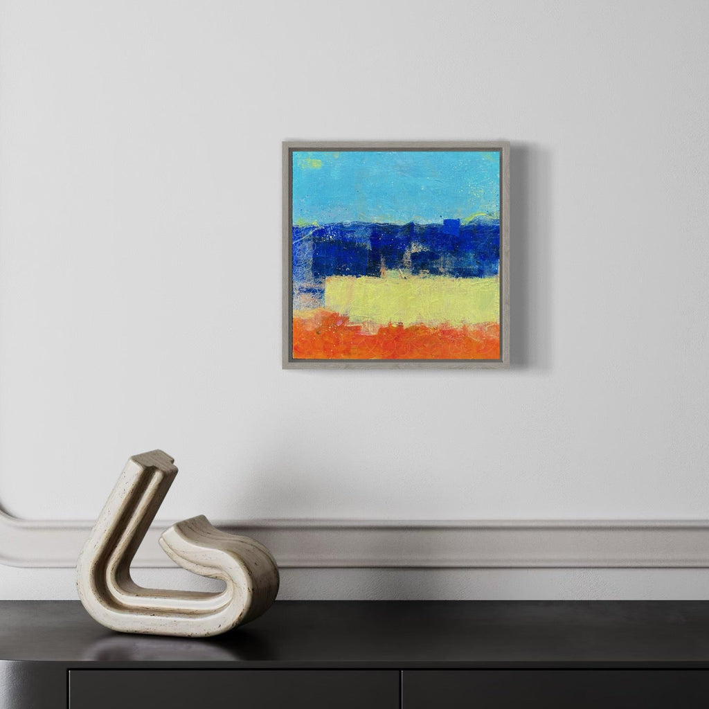 The artwork 'Sapphire Sunset' by Karen L. Burns features bold horizontal bands of vibrant colors: a luminous turquoise sky, deep sapphire blue horizon, warm yellow middle ground, and rich orange foreground. The acrylic painting showcases textured brushstrokes and abstract landscape elements in a 12x12 inch square format with contemporary minimalist style.