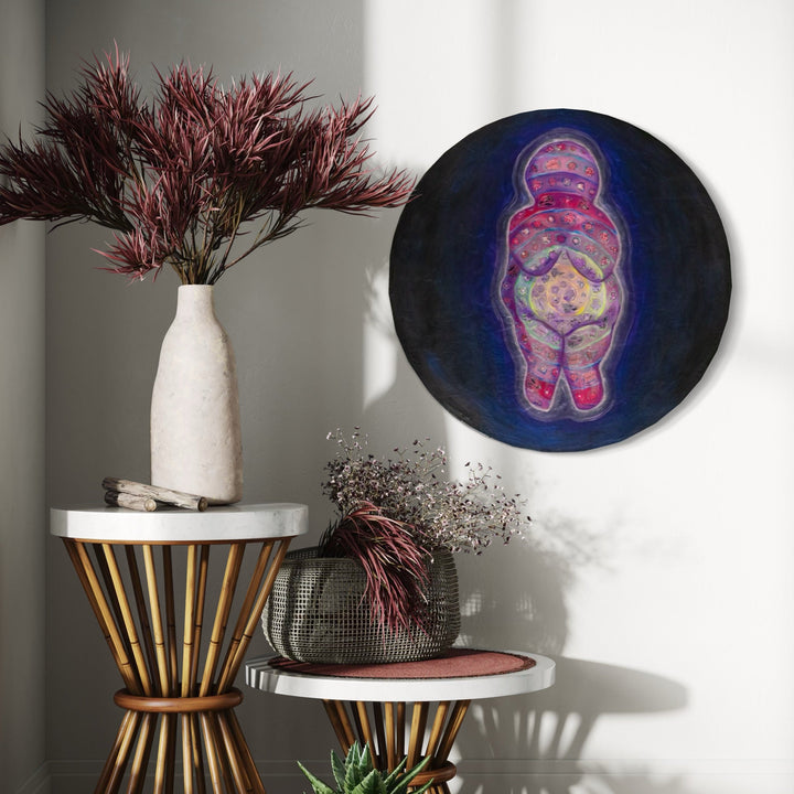 The artwork, She's Got the Whole World in Her Womb, by Laurie Shapiro, displayed in a room.