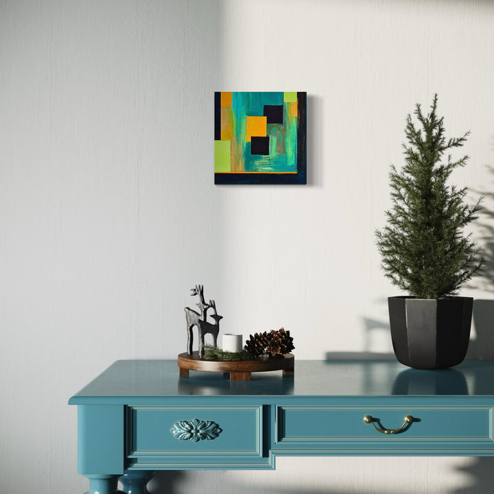 The artwork 'Spring Rain' by Vanessa Ryan features bold geometric abstract shapes in vibrant turquoise, yellow, and black. The acrylic painting on 12x12 canvas creates a modern composition with overlapping rectangular forms, suggesting depth and movement. The interplay of warm and cool tones evokes the fresh feeling of spring precipitation against an urban landscape.