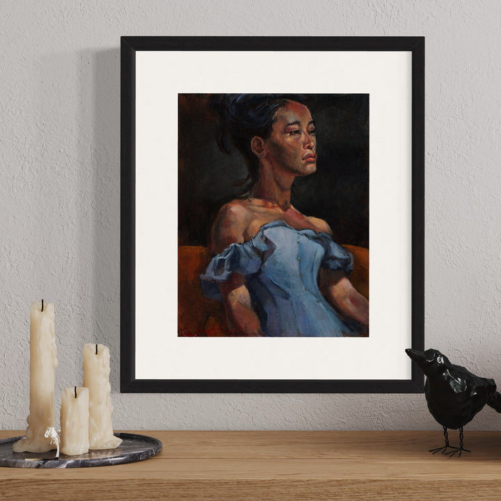 The artwork 'Summer Blue' by JaeMe Bereal features a portrait in dramatic lighting, showing a figure in an elegant off-shoulder powder blue dress against a rich dark background. The acrylic painting captures the interplay of light and shadow, with warm terracotta tones contrasting the cool blue fabric. Expertly framed, 14x11 inches, by JaeMe Bereal.