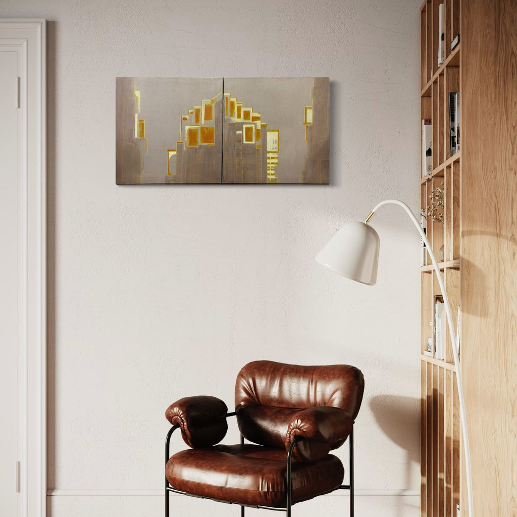 The artwork 'Sunset in the East-5' by Cora Jane Glasser features a contemporary diptych oil painting with abstract geometric shapes in luminous gold and yellow against a neutral taupe background. The composition suggests an architectural cityscape with angular forms and vertical elements, creating a modern, minimalist aesthetic on stretched canvas spanning 40 inches wide and 20 inches high.