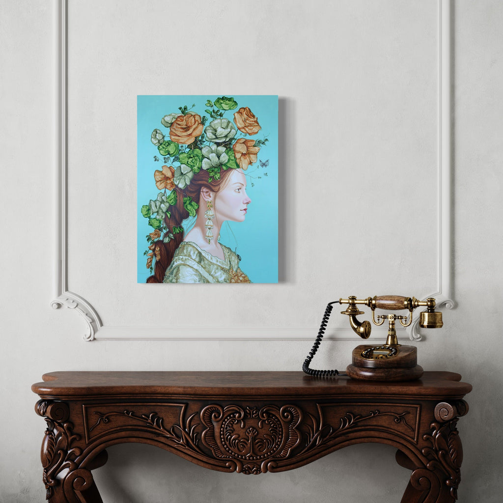 The artwork 'Symbols and Icons I' by Carlos Gamez de Francisco features a profile portrait adorned with lush peach roses and vibrant green foliage against a serene turquoise background. The figure wears an ornate vintage-style dress, creating a Renaissance-inspired composition. Painted in acrylic on wood, the 18x24 inch piece blends classical and contemporary elements.