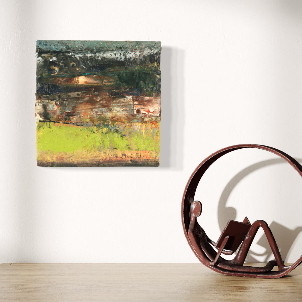 The artwork 'Tempest II' by Christopher Blyth features horizontal layers of textured encaustic painting, transitioning from deep forest greens at the top through earthy browns to a vibrant chartreuse base. The mixed media technique creates a weathered, atmospheric effect reminiscent of a stormy landscape, with rich textures and organic color blending on a 12x12 inch panel.