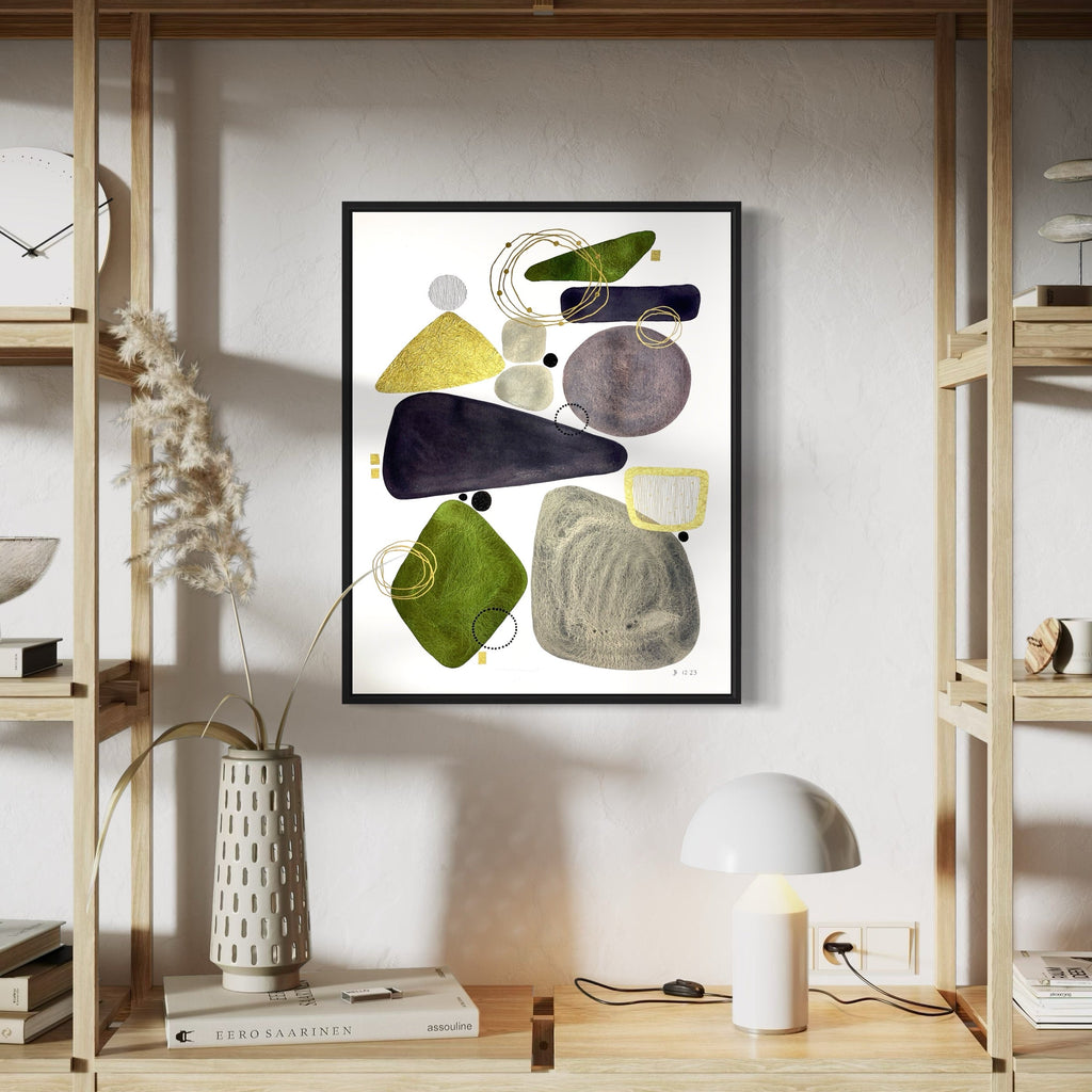 The artwork 'Tête-à-Tête' by Jocelyn Benford features abstract organic shapes in watercolor, including deep navy, olive green, and mustard yellow forms against white paper. The composition shows flowing geometric elements with textural brushwork and mixed media detailing, creating a modern minimalist aesthetic in a black frame by Jocelyn Benford.