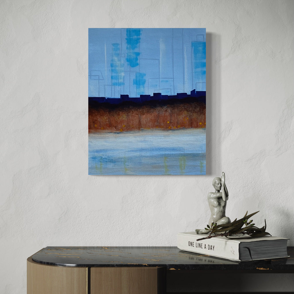 The artwork 'The Blue Hour (distant)' by Cora Jane Glasser depicts an abstract landscape with a vibrant blue sky, dark urban silhouettes, and earthy brown terrain meeting a misty pale blue water body. The oil painting on linen showcases a minimalist composition with horizontal layers, creating a serene atmospheric perspective suggestive of a cityscape at dusk.