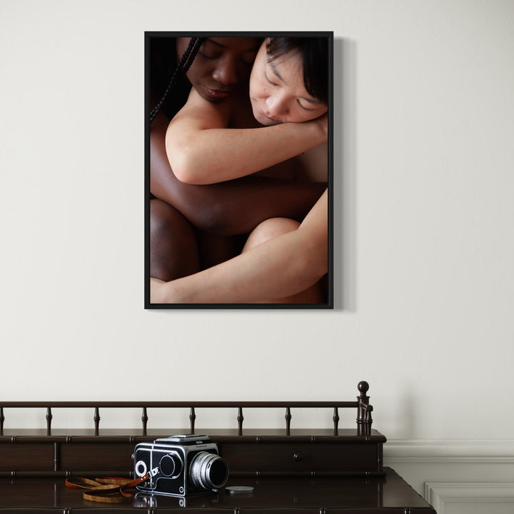 The artwork 'The Celestial (s)' by Eunice Pais captures an intimate abstract photographic composition featuring contrasting skin tones in warm lighting. The 27x18 inch framed piece emphasizes gentle curves and shadows, creating a contemplative artistic study of form and texture. Fine art photography by Eunice Pais.