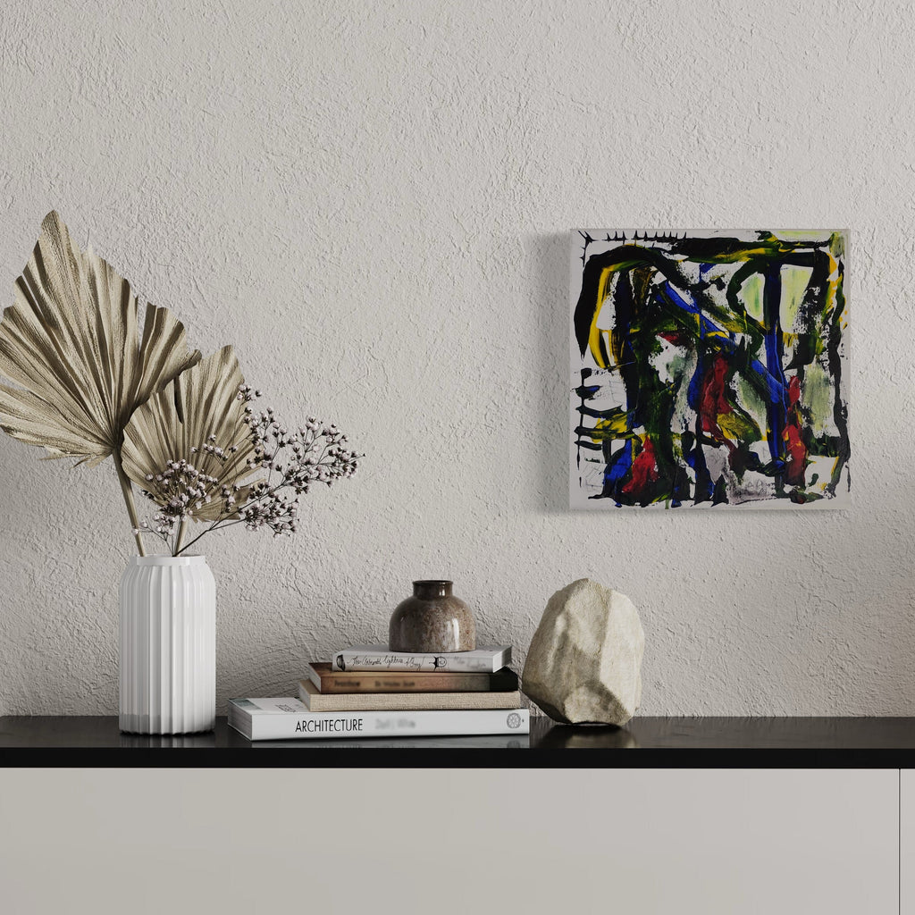The artwork 'The Tiger and the POPE' by Devin Ruiz features bold abstract expressionism with dynamic splashes of blue, yellow, and black paint against a white canvas. The composition shows spontaneous brushstrokes and gestural marks creating an energetic, modern aesthetic. Vibrant colors intersect with dark elements in a 13x13 inch acrylic painting by Devin Ruiz.