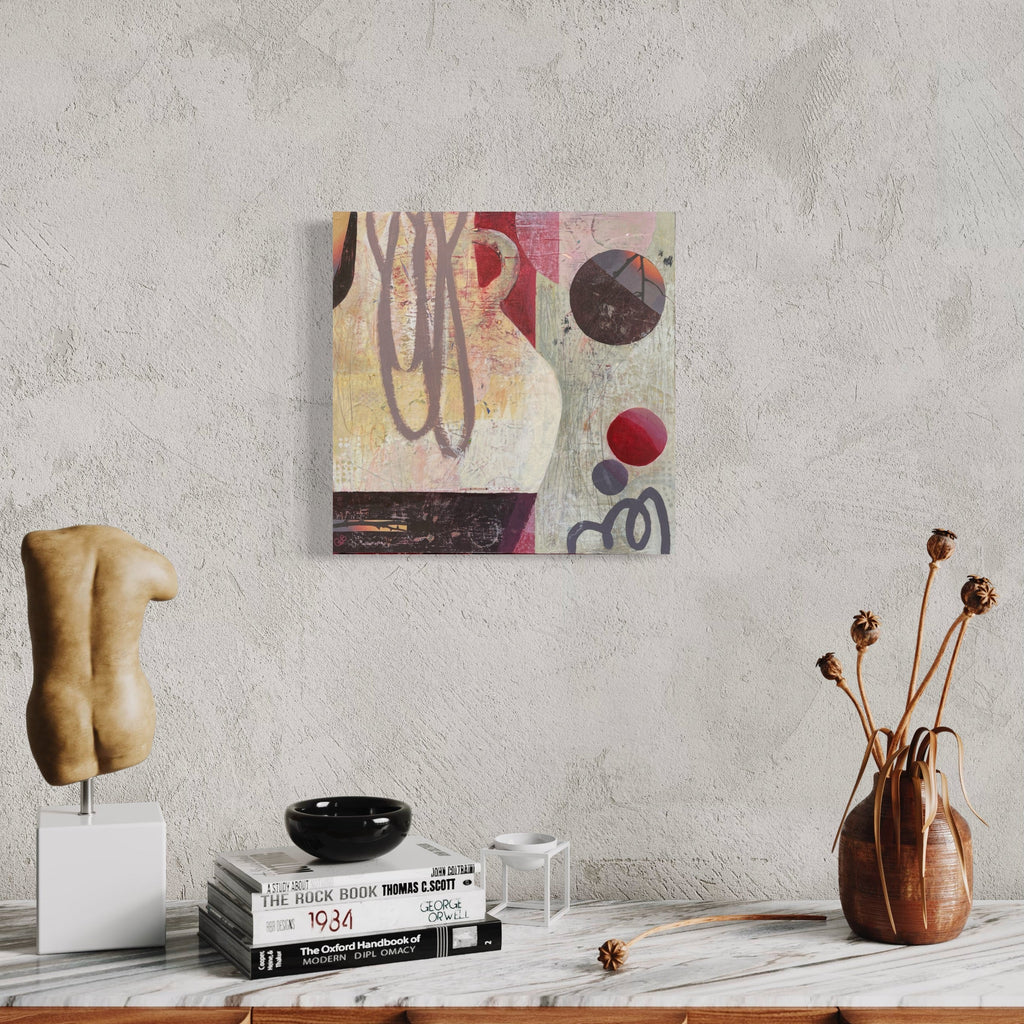 The artwork 'Time Will Tell' by Giliane Bader features abstract geometric shapes with circular motifs in burgundy, black, and pale yellow tones. Fluid brushstrokes and organic lines create dynamic movement across the mixed media composition, set against a textured off-white background. The 18x18 inch piece combines cold wax finish on birch panel for rich depth and dimension. By Giliane Bader.