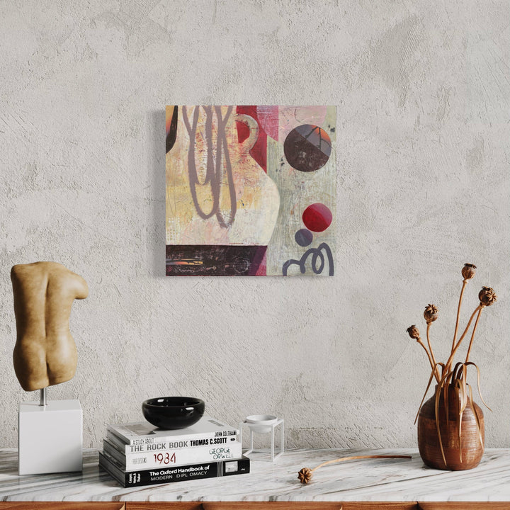 The artwork 'Time Will Tell' by Giliane Bader features abstract geometric shapes with circular motifs in burgundy, black, and pale yellow tones. Fluid brushstrokes and organic lines create dynamic movement across the mixed media composition, set against a textured off-white background. The 18x18 inch piece combines cold wax finish on birch panel for rich depth and dimension. By Giliane Bader.