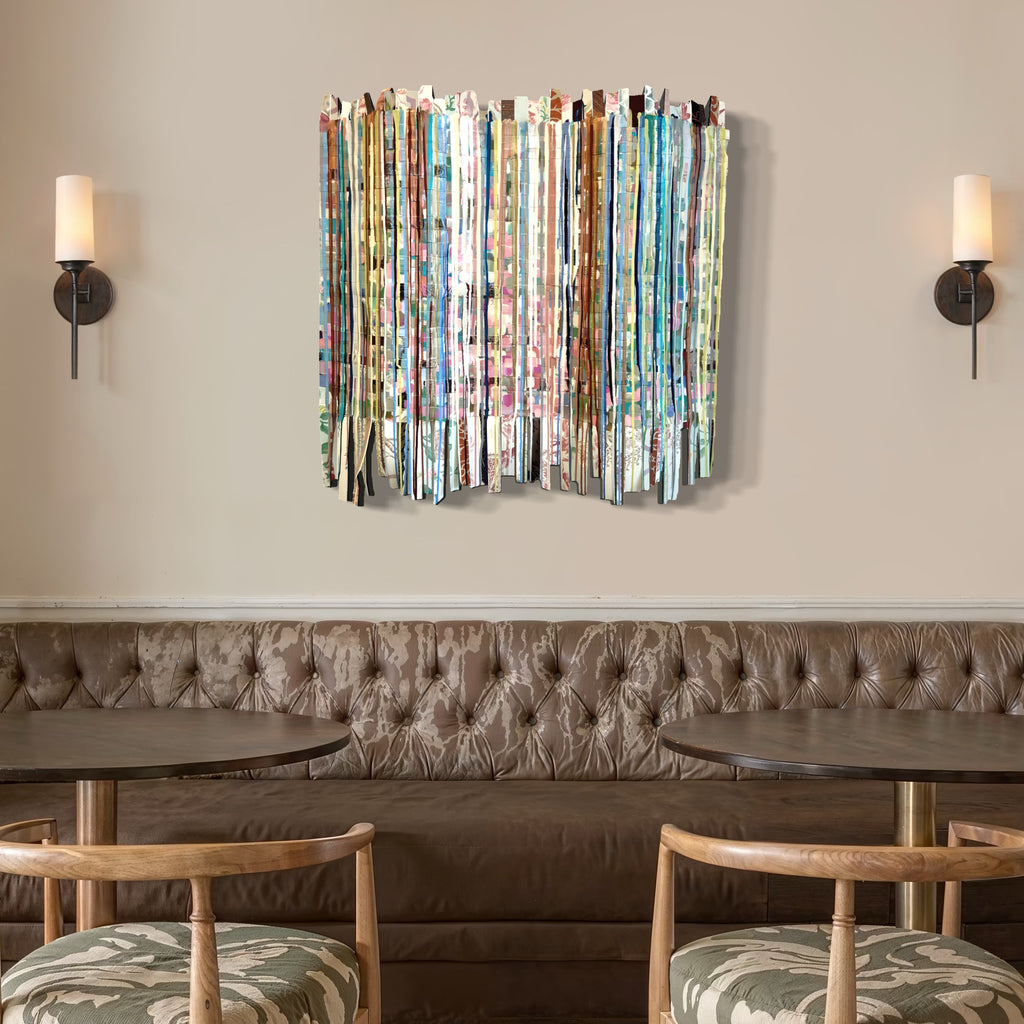 The artwork, Woven Lives, by Shiri Phillips, displayed in a room.