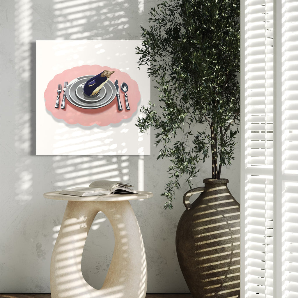 The artwork 'Eating Animals (Eggplant Penguin)' by Lori Larusso depicts a minimalist table setting with stacked gray plates on a coral-pink oval placemat, accompanied by silverware. The contemporary acrylic painting on polymetal features clean lines and a graphic style, measuring 27 x 16 inches.