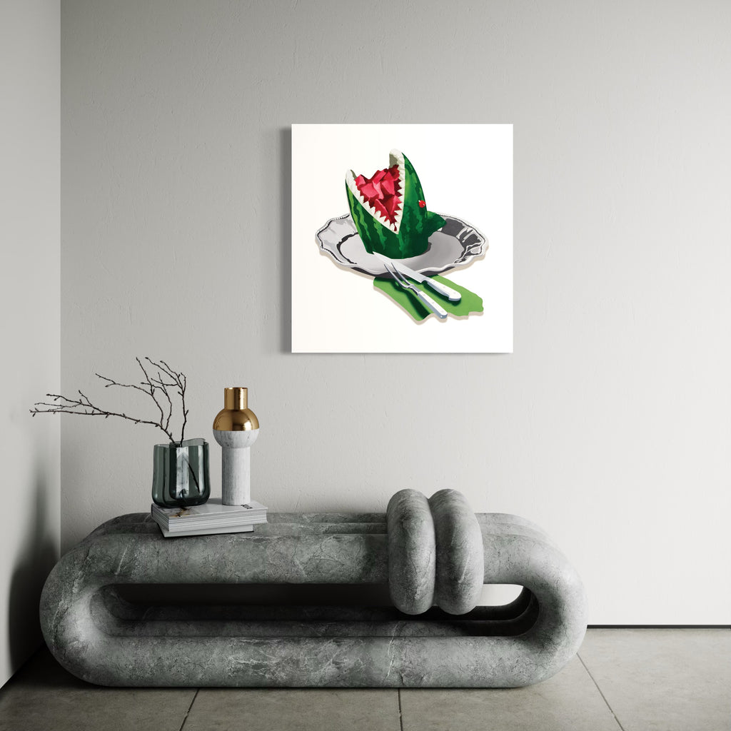 The artwork 'Eating Animals (Watermelon Shark)' by Lori Larusso features a cut watermelon crafted to resemble a shark's open mouth, displayed on a silver plate with utensils. The vibrant red flesh contrasts with the green rind, painted in acrylic on a white polymetal panel with precise, pop art-style execution and clean lines.