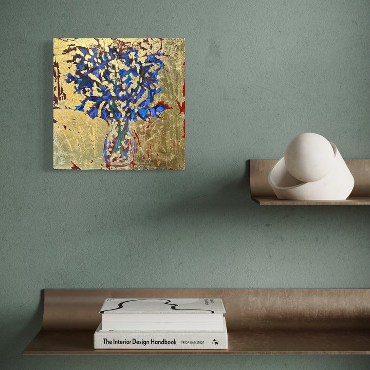 The artwork, Irises in glass vase, by Owen Brown, displayed in a room.