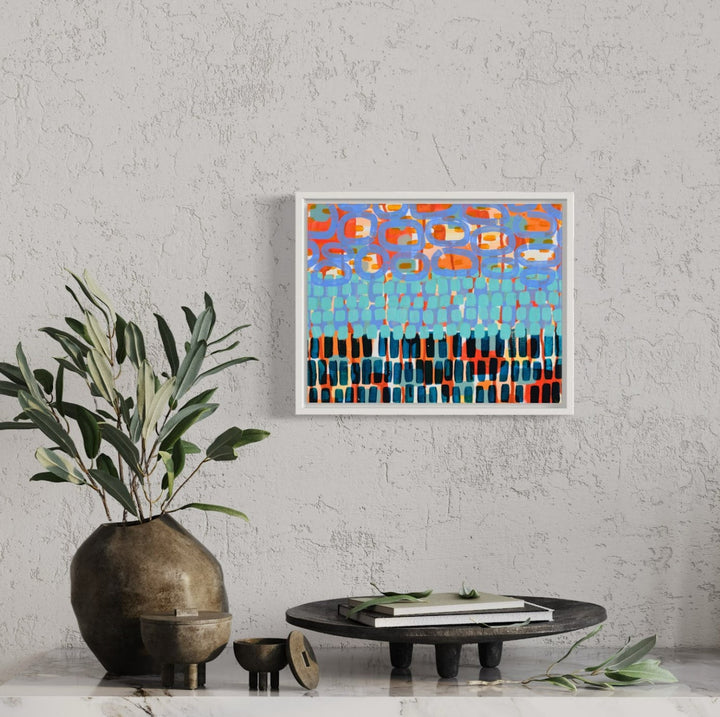 The artwork 'In the Clouds, No.5' by Taylor Binda features an abstract mosaic-like composition with vibrant orange and red shapes floating in a bright blue sky above a geometric pattern of black and turquoise rectangles. The acrylic painting on canvas creates a dynamic contrast between warm and cool tones, suggesting a stylized landscape view with a modern, expressionist approach. - Taylor Binda