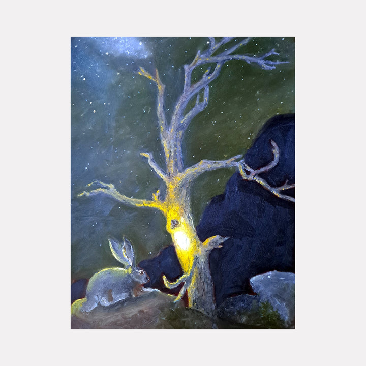 The artwork 'Black Tailed Jackrabbit' by Johanna Ryan depicts a mystical nighttime scene with a luminous tree trunk glowing yellow against a deep forest-green background. A detailed jackrabbit rests near grey rocks beneath the twisted, silvery branches, surrounded by starry specks in the dusky atmosphere. Oil on mylar painting captures ethereal lighting effects.