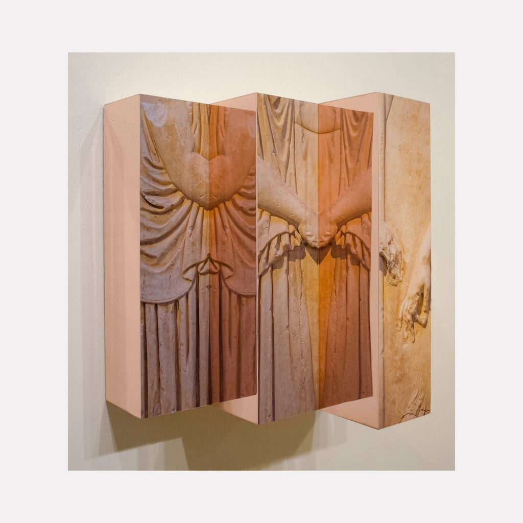 The artwork 'Eleusinian Reflective Relief' by Ryan Frank features a triptych-style wall sculpture combining wood and copper elements. Three dimensional panels display flowing, draped fabric-like textures in warm copper tones, creating dramatic shadows and vertical ripples. The center panel showcases distinctive carved patterns with ethereal lighting effects. By Ryan Frank.