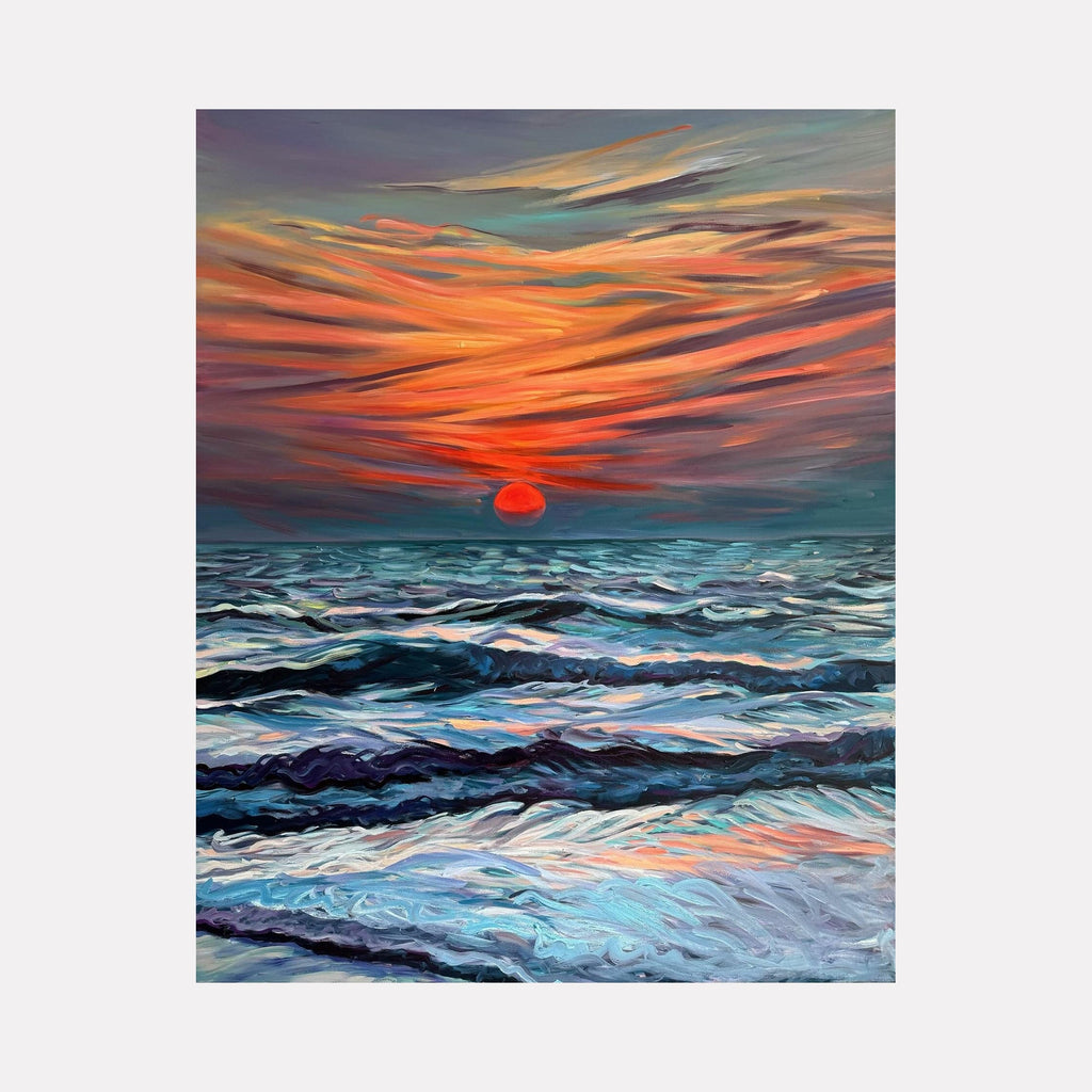 The artwork 'Goan Sunset' by Claudia Robles-Gil captures a dramatic seascape with turbulent waves in shades of deep blue and turquoise beneath a vibrant orange and coral sky. A large red sun descends on the horizon, casting warm reflections across the choppy ocean waters. The dynamic brushstrokes create movement in both sky and sea, painted in oil and acrylic on canvas.