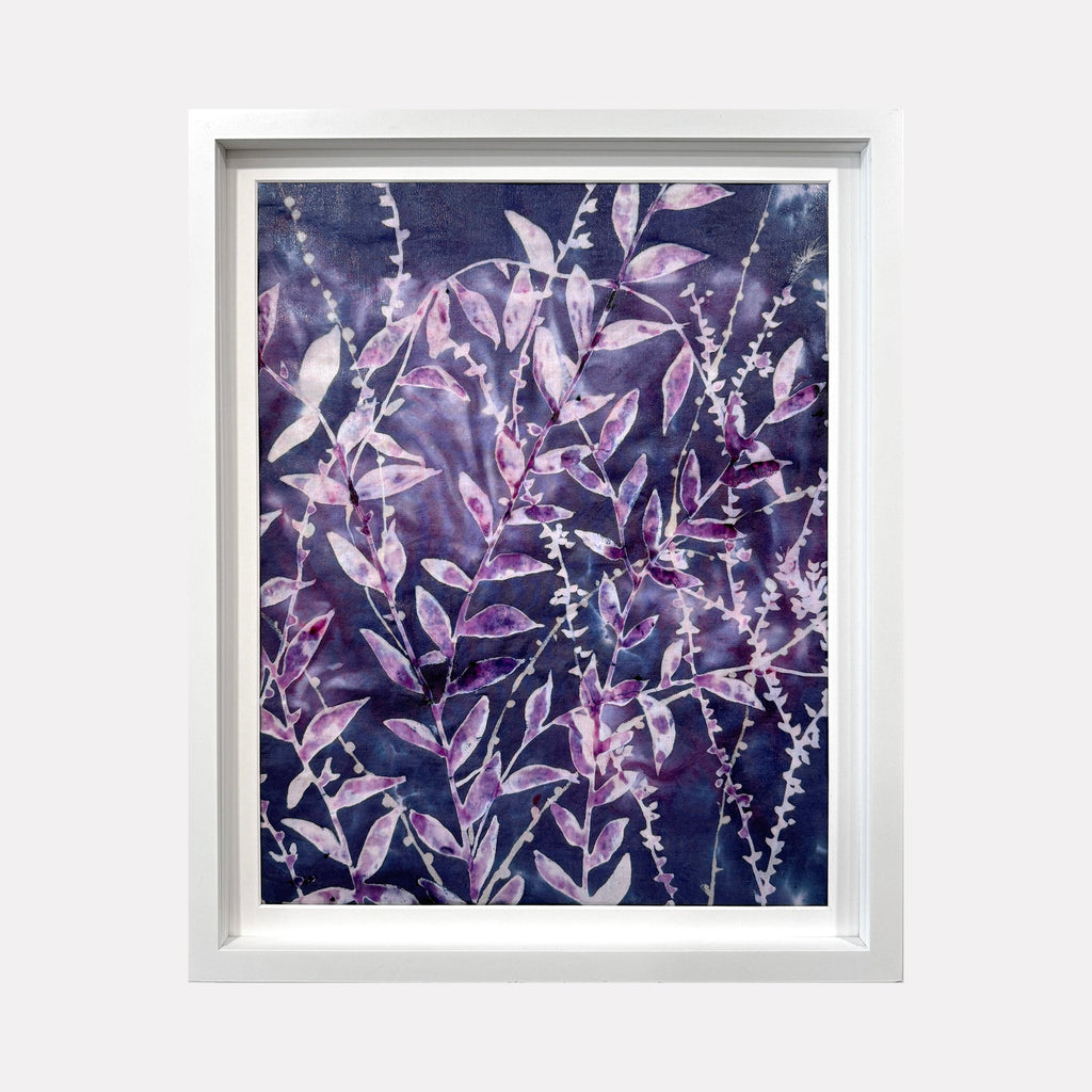 The artwork 'Iced Sky I' by Rachel Kohn features delicate botanical patterns in ethereal purple and pink hues. Flowing leaves and branches create an organic composition against a deep indigo background. The dye and bleach technique creates a dreamy, crystalline effect, with white accents resembling frost or starlight throughout the cotton canvas.