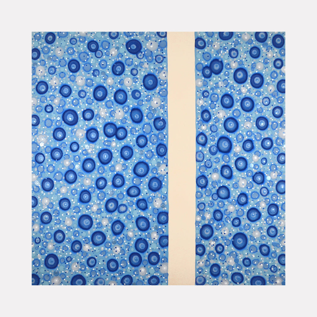 The artwork 'Implicate Order' by Eric Jiaju Lee features a mesmerizing pattern of circular blue forms scattered across a light blue background, divided by a vertical cream-colored strip. The circles appear as concentric rings in varying shades of navy and cerulean blue, creating a cellular or bubble-like effect. The organic, flowing pattern suggests movement and depth on the acrylic canvas surface.