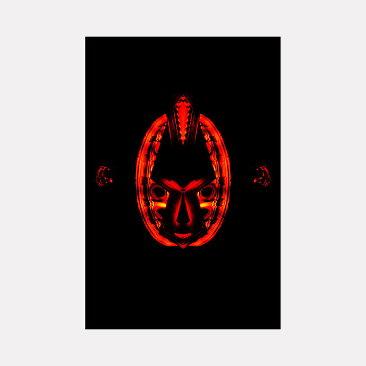 The artwork 'Mask' features a striking red tribal-style mask glowing against a deep black background, creating dramatic contrast. The design showcases symmetrical geometric patterns with angular details and curved elements forming an oval shape. Photographed in a minimalist style measuring 24x36 inches by Cavier Coleman.