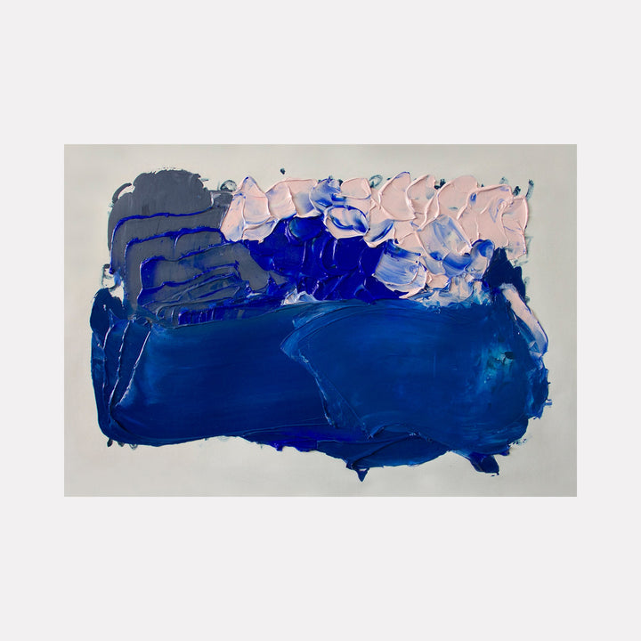 The artwork 'Suspiro 191' by Carin Kulb Dangot features bold strokes of deep cobalt blue dominating the canvas, with delicate pink and white accents creating a cloud-like formation along the top edge. The abstract composition showcases textural brushwork and dynamic movement through layered acrylic paint, measuring 38 x 56 inches.