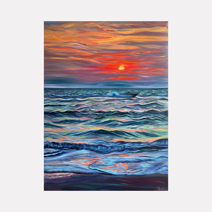 The artwork 'The Moment Is All There Is' by Claudia Robles-Gil depicts a vibrant seascape with rolling waves in shades of turquoise and deep blue beneath a dramatic sunset sky. Bold orange and red streaks paint the horizon, while a glowing sun disk reflects on the undulating ocean surface, creating a mesmerizing interplay of warm and cool tones through expressive brushstrokes in oil and acrylic on canvas.