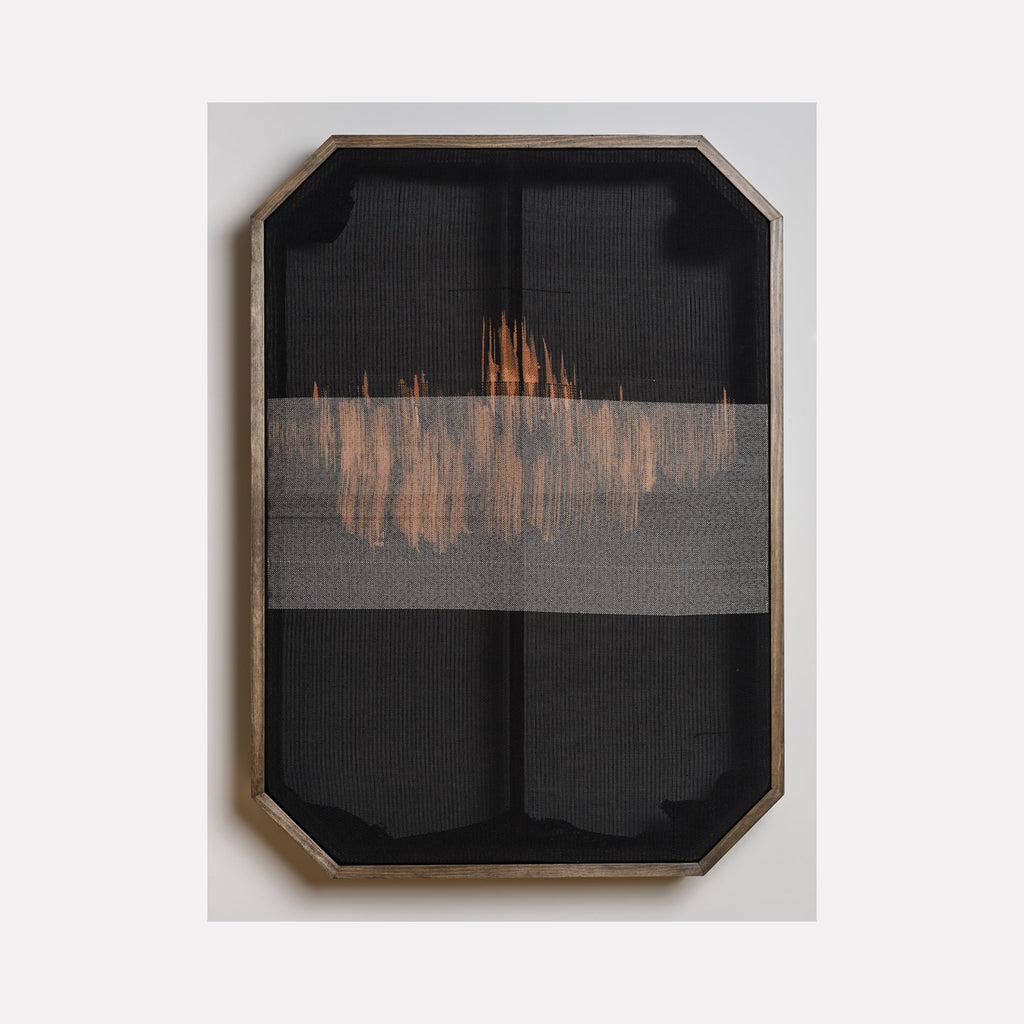 The artwork 'Untitled 104' by Victoria Manganiello features a minimalist fiber composition with a horizontal band of copper-toned weaving across charcoal black background. The textural piece, framed in a geometric wooden border, showcases natural and synthetic fibers creating an abstract horizon-like effect, with subtle variations in weave density.