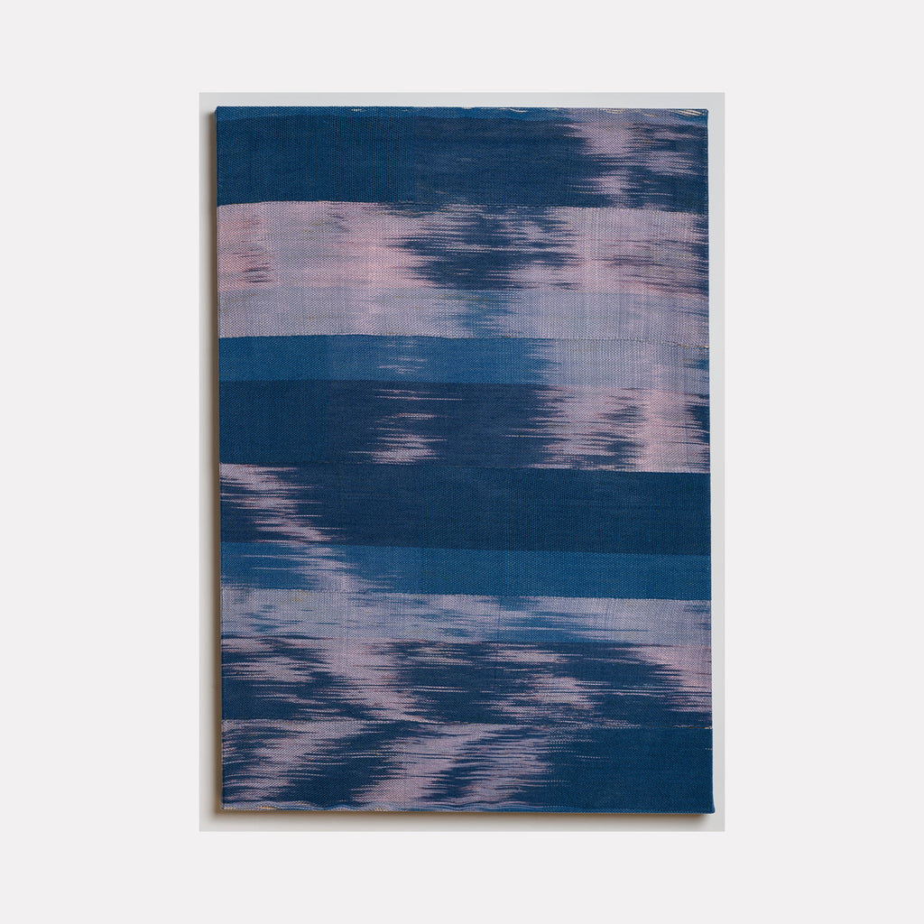 The artwork 'Untitled 156' by Victoria Manganiello features horizontal brushstrokes in deep navy blue and soft pink hues, creating a dreamy watercolor-like effect. The textured surface, created with natural and synthetic fibers, displays a rhythmic pattern of blended colors reminiscent of reflections on water or cloud formations at dusk.