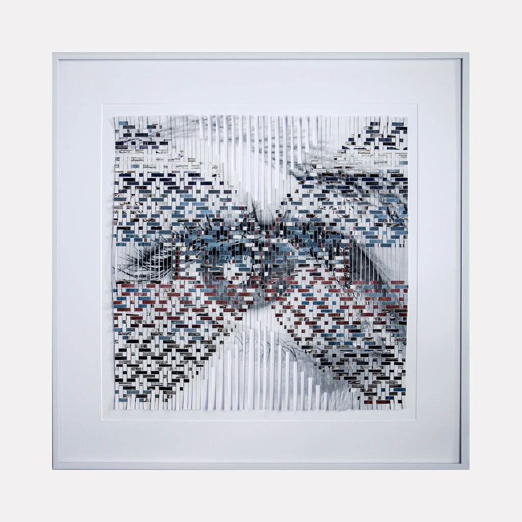 The artwork 'Vestiges' by Kiana Honarmand features a striking geometric composition with pixelated patterns in black, white, and subtle blue tones. Vertical lines intersect with mosaic-like squares, creating an X-shaped formation against a white background. The digital-inspired abstract design is framed in a clean white border, measuring 28 x 28 inches.