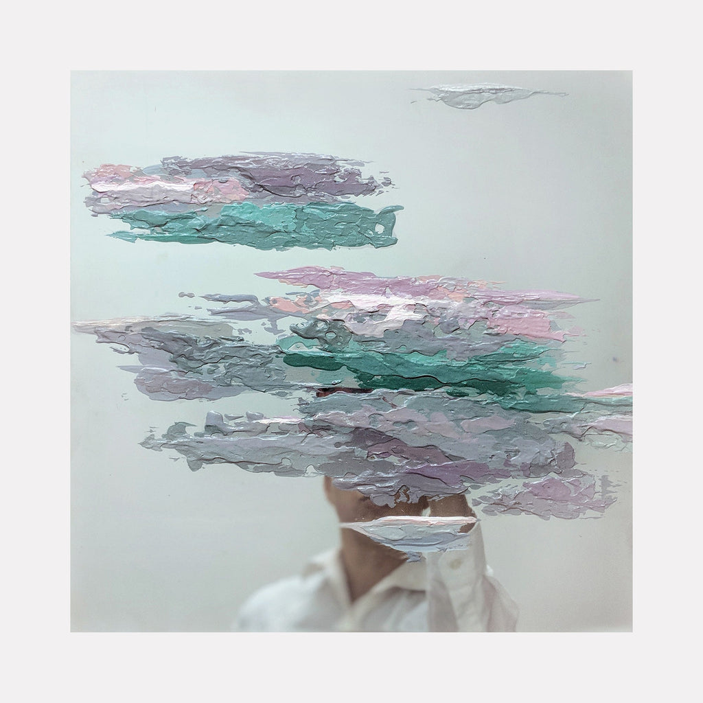 The artwork 'Fluidity #22' by Sofia Echa features ethereal abstract clouds in soft teal, mauve, and gray tones, painted with acrylic on stainless steel. The composition shows flowing, layered brushstrokes creating a dreamy, atmospheric effect against a misty pale background, measuring 12x12 inches.