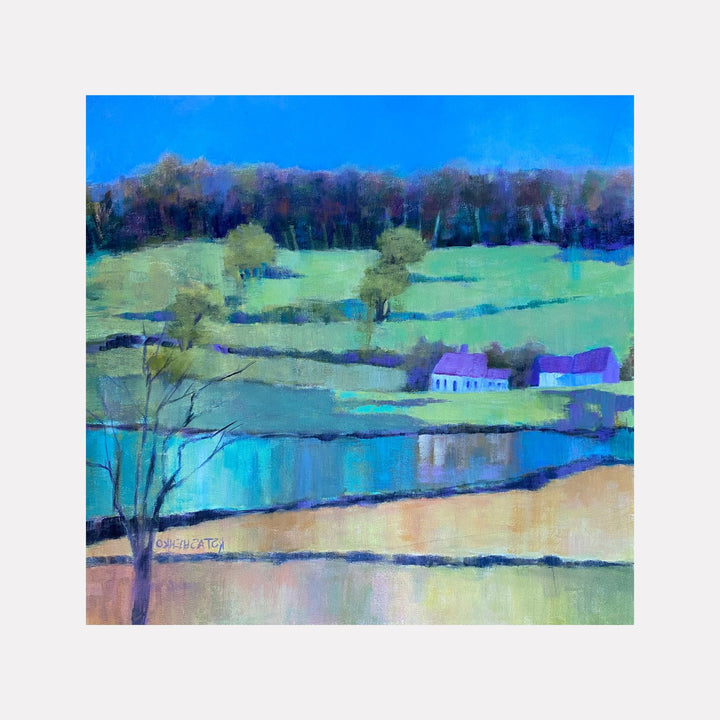 Early Spring in Wales by Kristin Stashenko portrays a serene rural landscape with softly undulating green fields, a reflective body of water, and a cluster of quaint cottages under a vibrant blue sky, evoking a fresh and peaceful atmosphere characteristic of the season’s arrival.