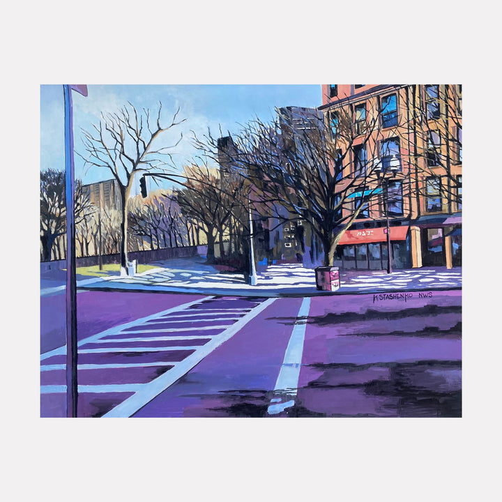 Intersection by Kristin Stashenko depicts a quiet urban street corner bathed in soft light with bare trees lining the sidewalk. The scene features warm-toned brick buildings contrasted with cool shadows crossing the pavement, evoking a serene, contemplative moment in a cityscape during early morning or late afternoon.