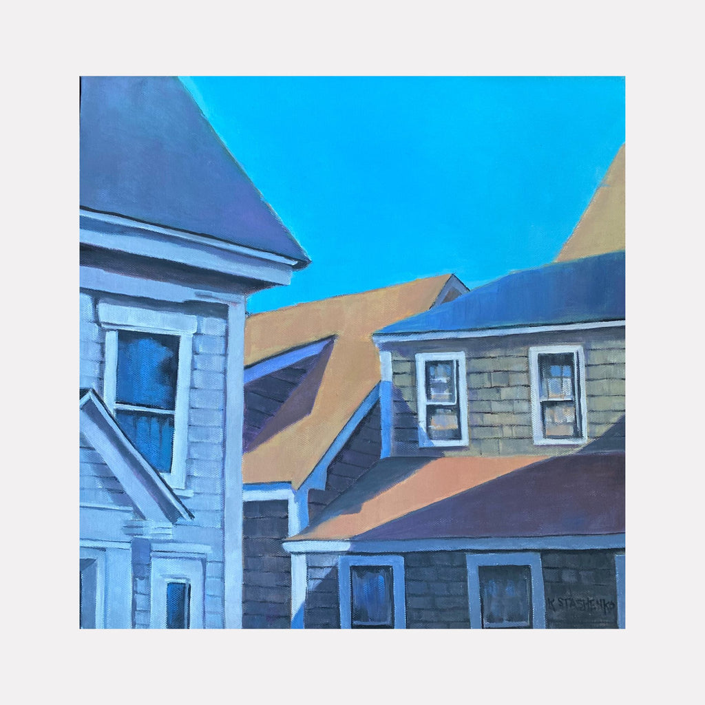 Summer Rooftops by Kristin Stashenko portrays a cluster of sunlit rooftops and dormer windows under a vibrant blue sky. The composition blends warm ochre and cool gray tones, capturing the quiet geometry and peaceful atmosphere of a suburban neighborhood bathed in summer light.