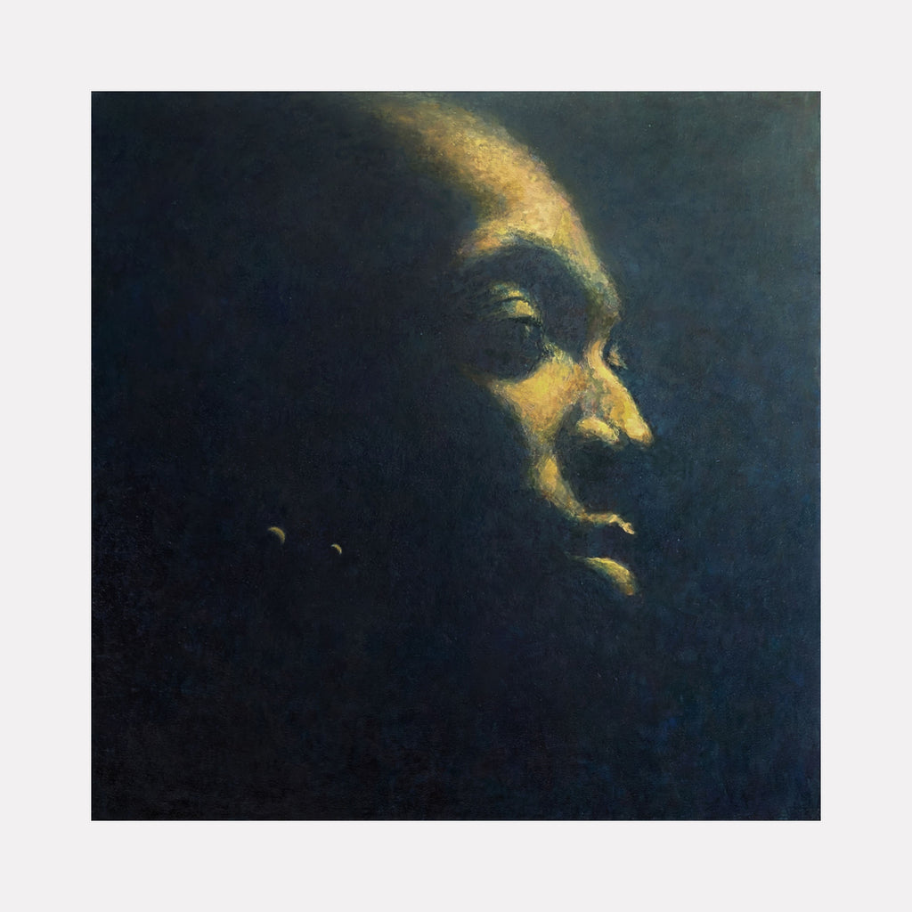 Earth by Ler Chang evokes a serene, contemplative male profile emerging from a deep, shadowed background. The subtle interplay of warm golden light and cool dark tones creates a meditative atmosphere, emphasizing quiet strength and introspection within a softly textured, almost ethereal space.