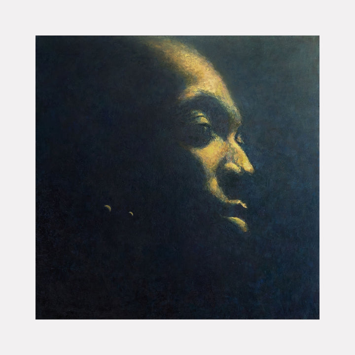 Earth by Ler Chang evokes a serene, contemplative male profile emerging from a deep, shadowed background. The subtle interplay of warm golden light and cool dark tones creates a meditative atmosphere, emphasizing quiet strength and introspection within a softly textured, almost ethereal space.