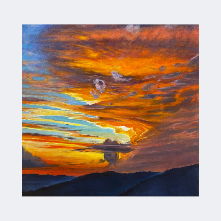 The artwork "Cortona" by Regina Miele captures a vivid sunset sky with swirling clouds in fiery oranges, deep reds, and soft yellows, contrasted by patches of blue and muted purples. The textured brushstrokes evoke the dramatic styles of J.M.W. Turner, blending natural beauty with a sense of dynamic movement over shadowed mountain silhouettes.