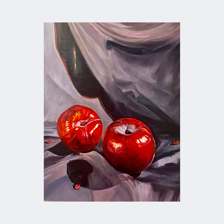 The artwork "Fruit and Seeds II" by Regina Miele features two glossy red fruits with smooth surfaces resting on a draped, soft-textured fabric in muted purples and grays, evoking the chiaroscuro and still life elegance reminiscent of Caravaggio's dramatic lighting and Vermeer’s delicate realism. The composition highlights rich color contrasts and subtle reflections.