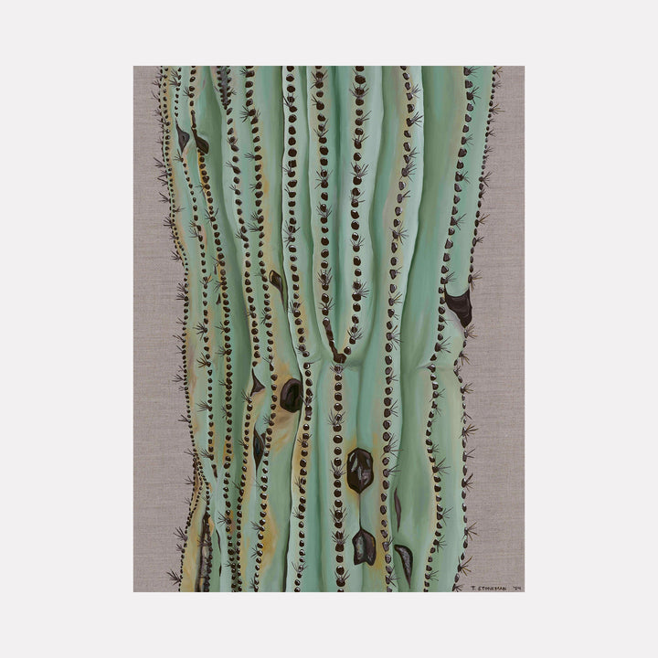 The artwork "The Desert Will Carry You" by Taylor Stoneman features a close-up of a tall cactus with soft green vertical ridges and dark brown spines arranged in rows. The textured background has a natural, linen-like appearance. The style echoes the detailed botanical illustrations of Georgia O'Keeffe combined with minimalist modern realism.