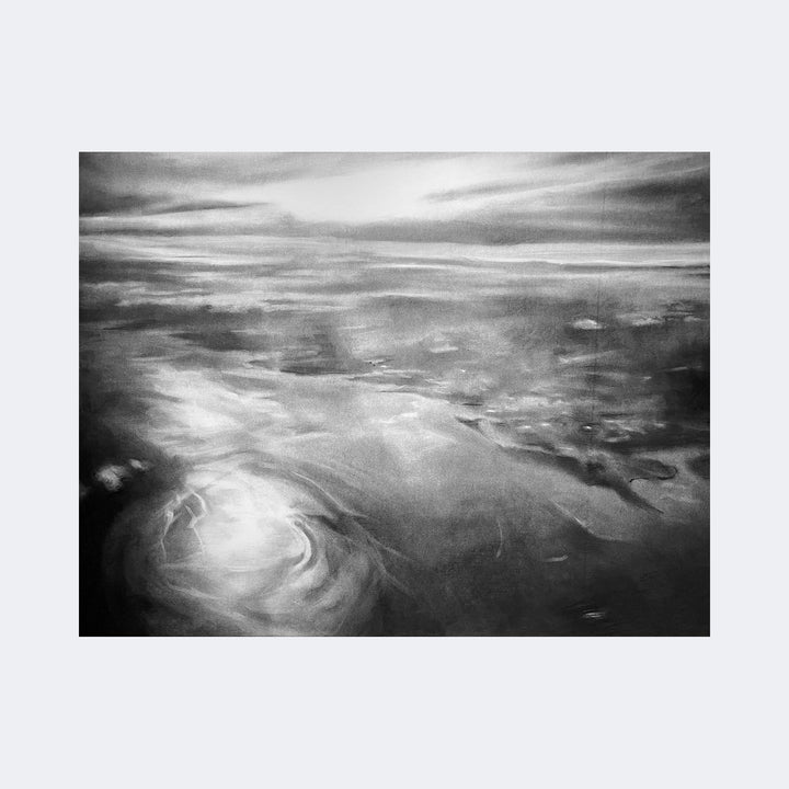 The artwork "In The Atmosphere" by Regina Miele features a monochromatic, abstract seascape with swirling water patterns and soft, cloud-like textures blending into a hazy horizon. The piece evokes the ethereal quality of J.M.W. Turner’s atmospheric landscapes and the moody tonal contrasts of contemporary charcoal drawings, creating a contemplative and immersive experience.