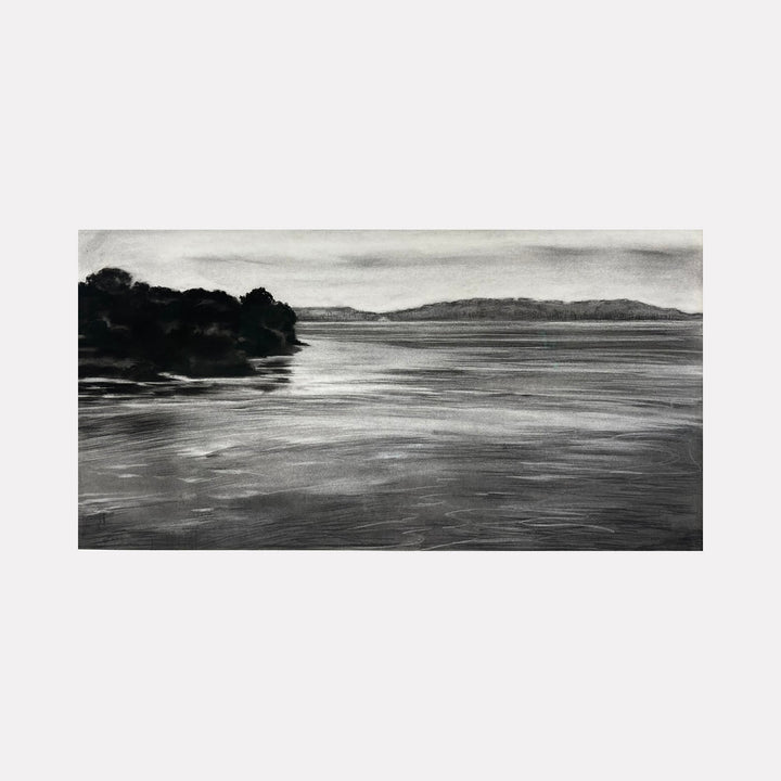 The artwork "Chesapeake to Gotham I" by Regina Miele depicts a serene lakeside or river scene in monochromatic tones with soft, textured brushstrokes. The dark silhouettes of trees contrast with the calm reflective water and distant hills under a cloudy sky. The style evokes the moody atmosphere reminiscent of works by Edward Hopper and James McNeill Whistler.